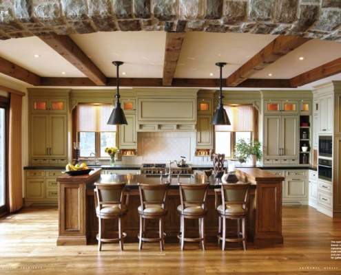 Cottage kitchen with breakfast bar, wood beams and hardwood floor.