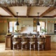 Cottage kitchen with breakfast bar, wood beams and hardwood floor.