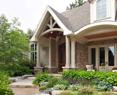 Mississauga home with natural stone, white doors and white columns.