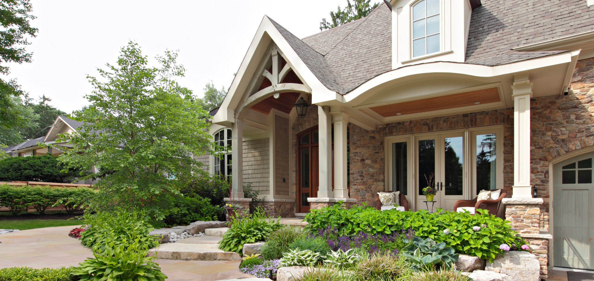 Mississauga home with natural stone, white doors and white columns.