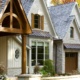 Traditional home with wood portico, natural stone and vertical siding.