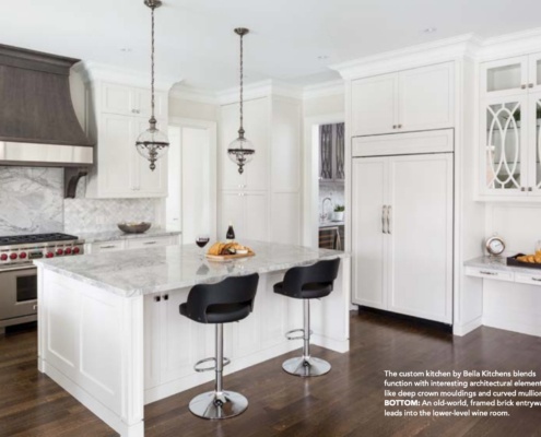 Custom kitchen with granite countertops, white cabinets and hardwood floor.