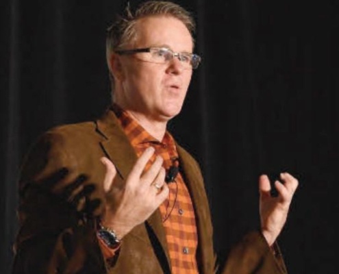 David Small speaking at a conference.