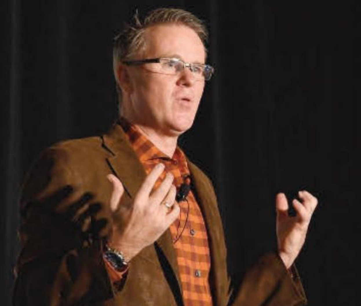 David Small speaking at a conference.
