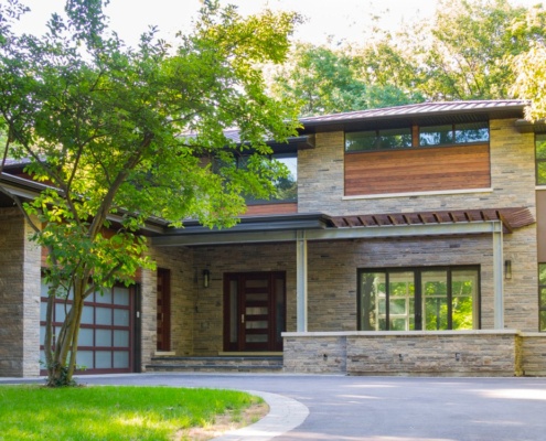 Modern renovation with steel beams, floating roof and wood trim.