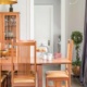 Dining room with wood dining table, gray walls and white trim.