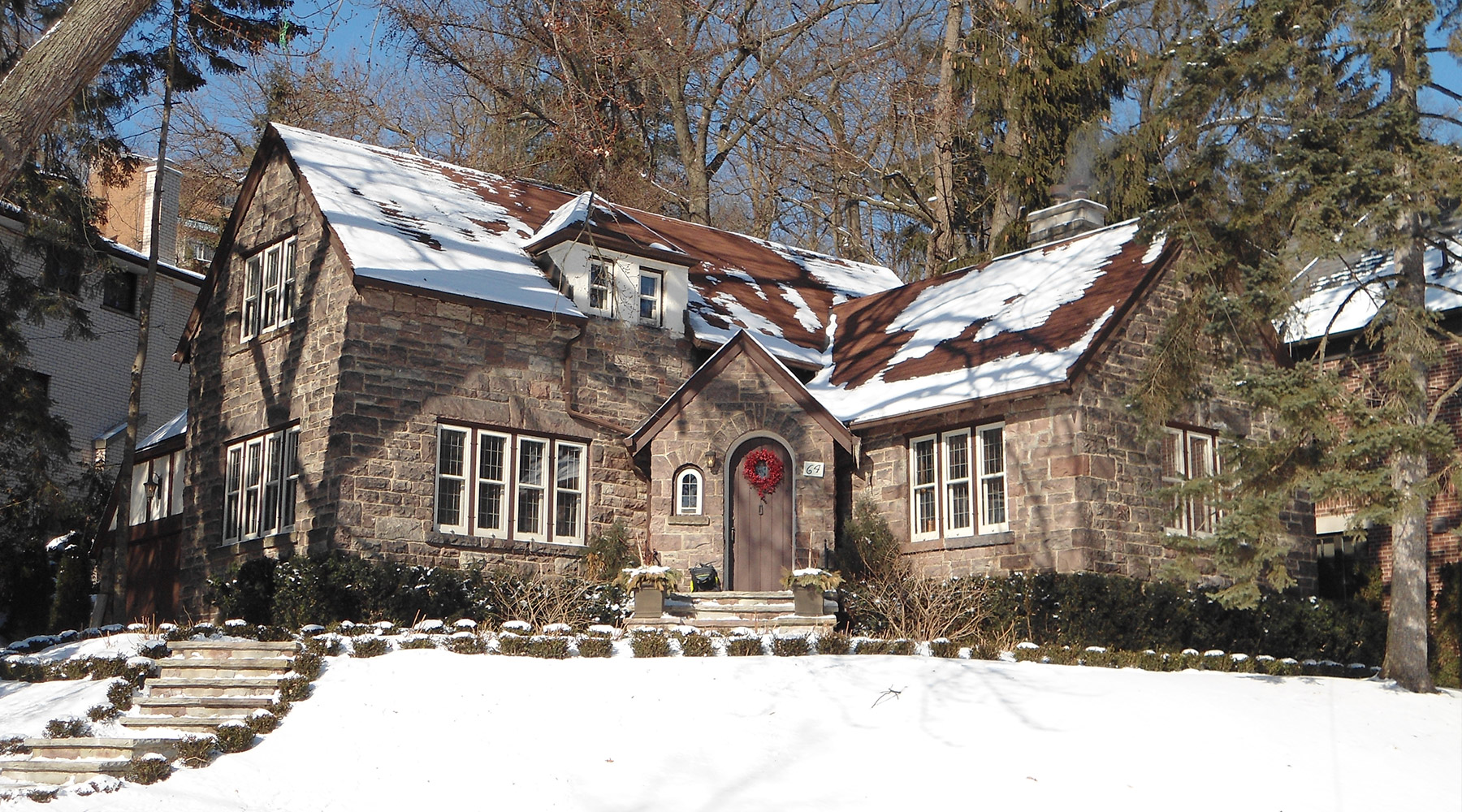 Tudor style home in snow.