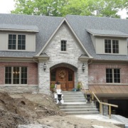 Traditional home with red brick, natural stone and copper detailing.