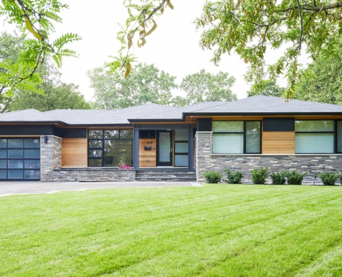 Modern home with floating roof, stone siding and steel column.