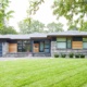 Modern home with floating roof, stone siding and steel column.