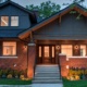 Toronto custom home with covered front porch, gabled roof and brick chimney.