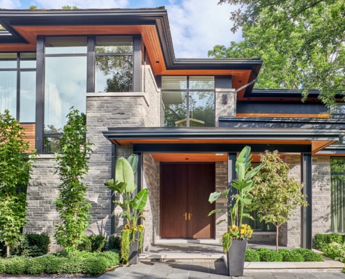 Contemporary house with double front door, angled wall and wood soffit.