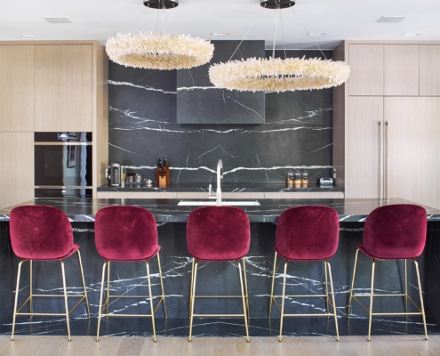 Oakville kitchen with marble island, wood floor and modern chandelier.