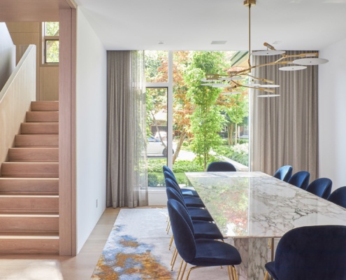 Contemporary house with white walls, wood stairs and hardwood floors.