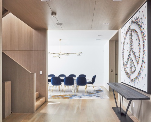 Modern dining room with white trim and wood stair.