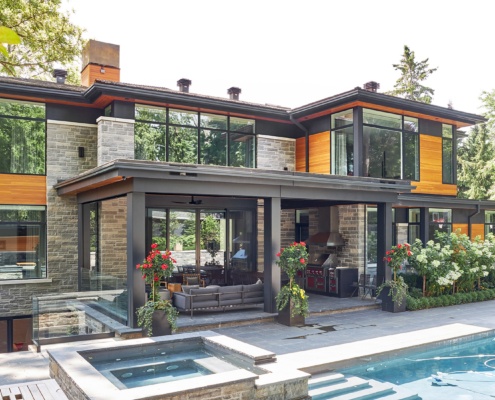 Natural modern home with inground pool, outdoor living space and wood soffit.