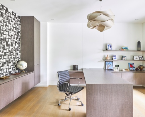 Modern home office with floating drawers, modern chandelier and hardwood floors.