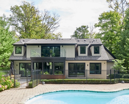 Mississauga home with gables, wood siding and glass balcony.