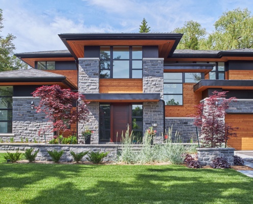 Modern home corner window, floating roof and stone columns.