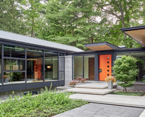 Mississauga bungalow with metal roof, concrete walkway and wood soffit.