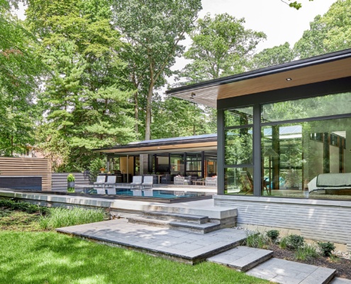 Mississauga bungalow with horizontal stone, wood siding and corner windows.