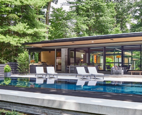 Custom home with steel beam, wood soffit and concrete deck.