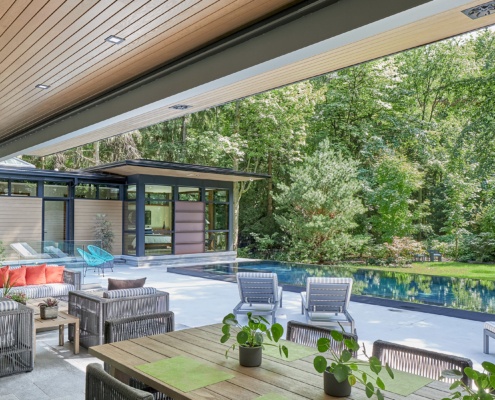 Modern deck with steel beam, concrete deck and inground lap pool.