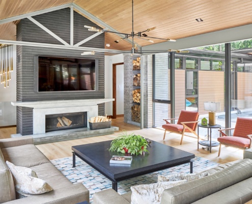 Custom home with steel beam, stone wall and concrete mantel.