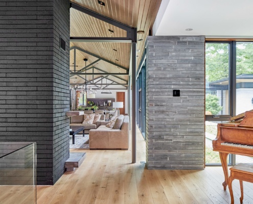 Modern home with concrete wall, hardwood floor and steel column.