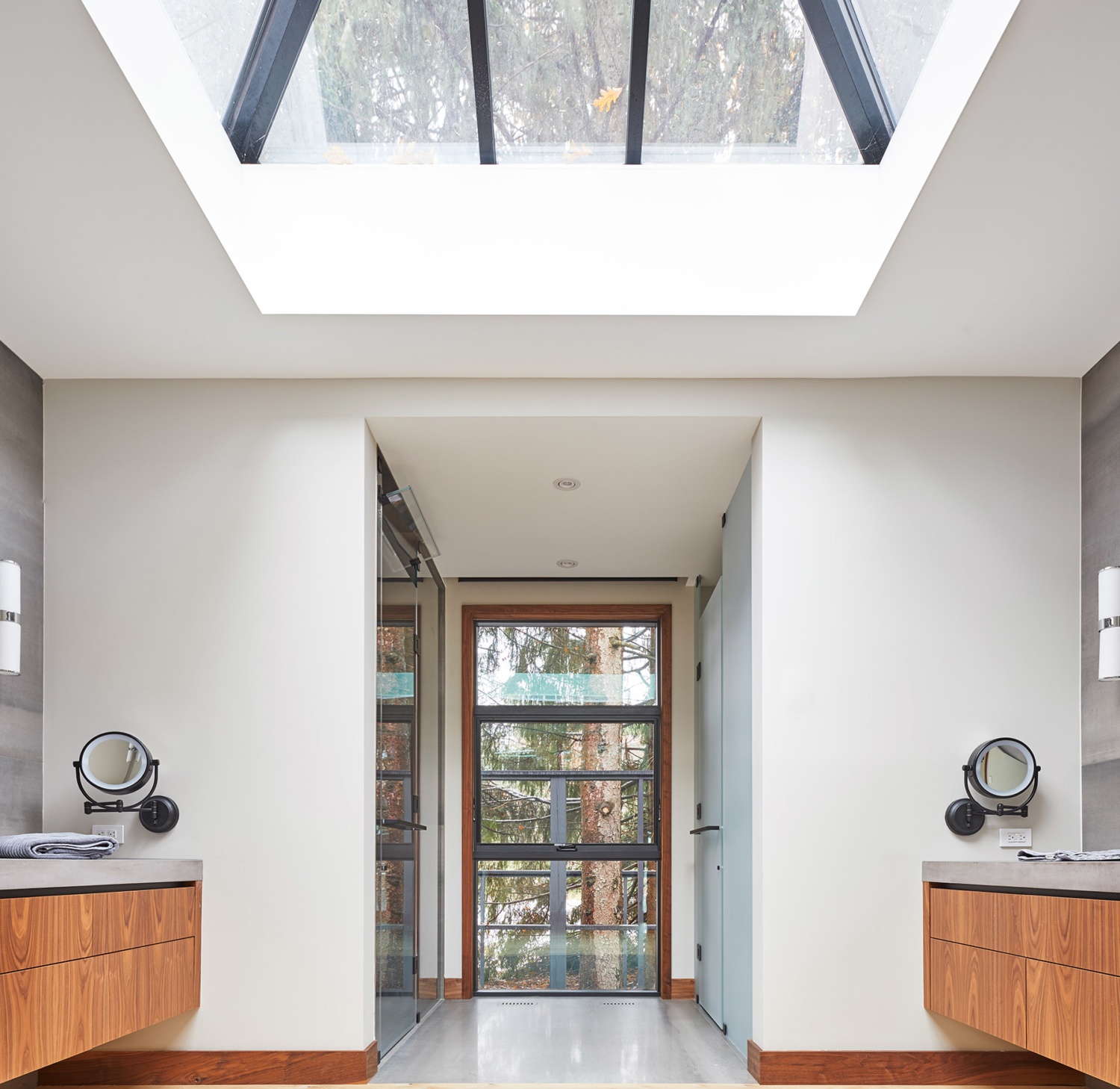 Master bedroom with skylight, floating vanity and tile floor.