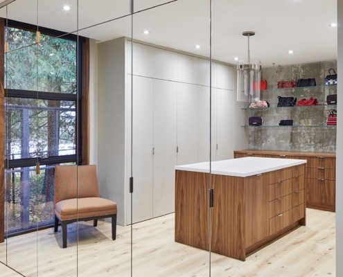 Dressing room with full length mirror, hardwood floor and island.