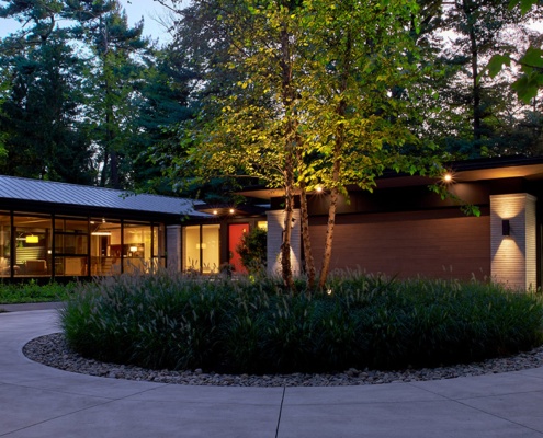 Bungalow with wood soffit and stone columns.