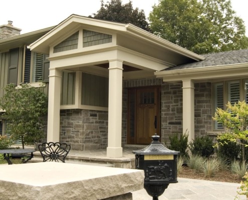 Mississauga renovation with shingled windows, green shutters and white trim.