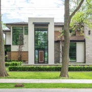 Ultra modern house with stucco, wood siding and natural stone.