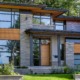 Toronto house with black frame windows, wood soffit and stone planter.