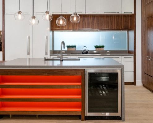 Modern kitchen with wood cabinets, gray island and white walls.