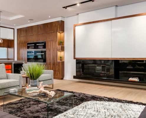 Living room with brown couch, gray couch and white frame windows.