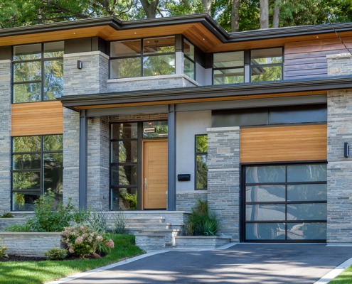 Toronto home with floating staircase, copper siding and frosted glass garage door.