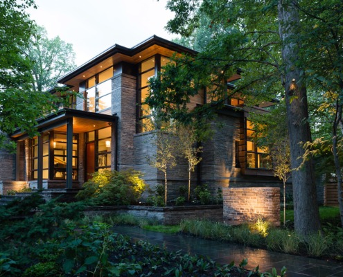 Natural modern home with wood soffit, natural stone and black trim.