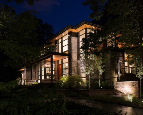 Mississauga house with horizontal stone, flat roof and wood soffit.