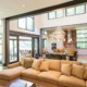 Living room with steel beam, black frame windows and white walls.