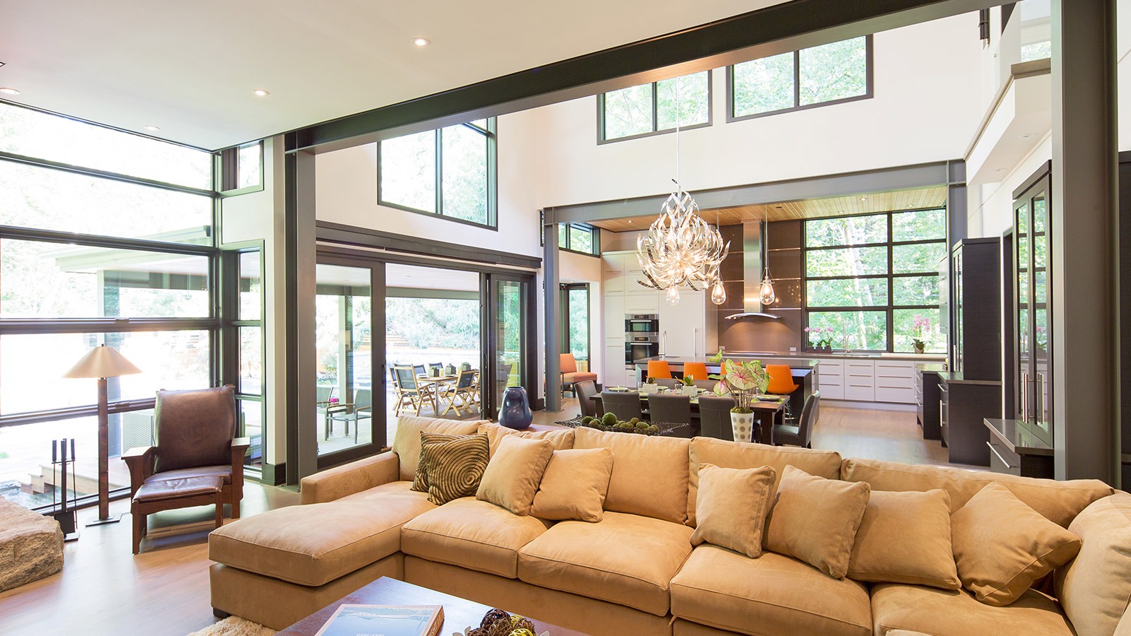 Living room with steel beam, black frame windows and white walls.