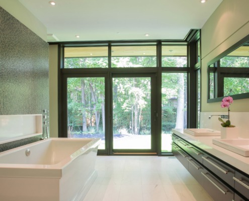 Master bathroom with tile wall, floating vanity and double sink.