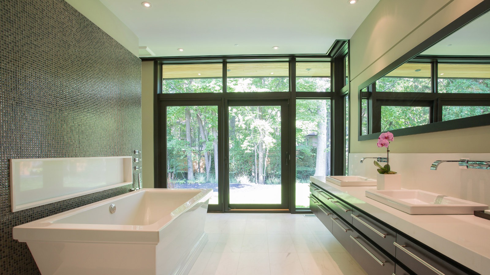 Master bathroom with tile wall, floating vanity and double sink.