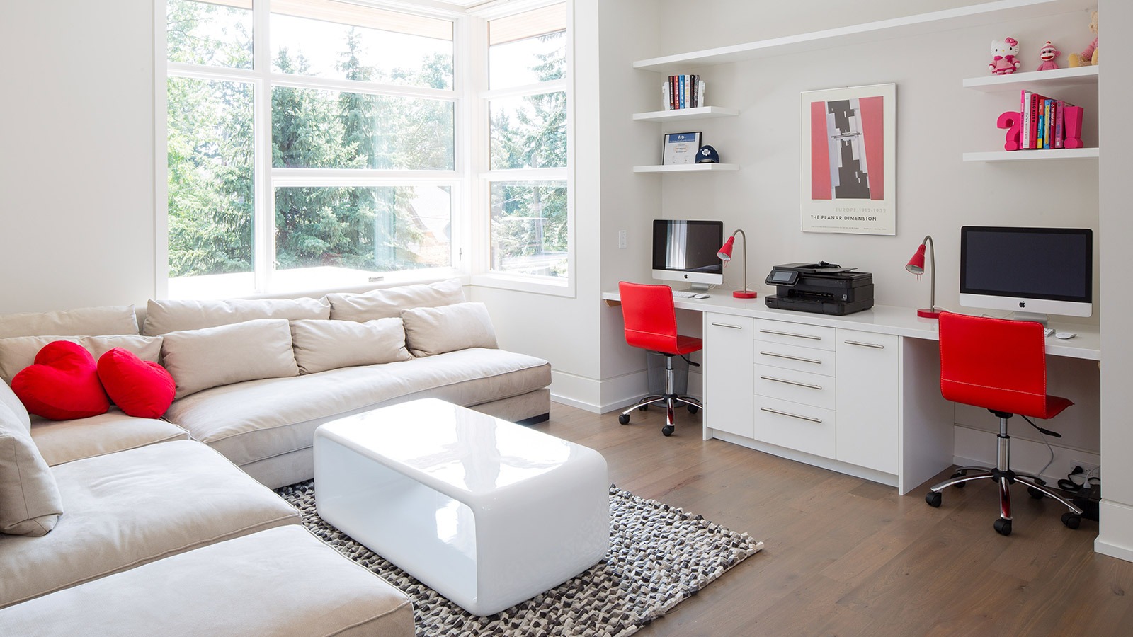 Den with corner window, white baseboard and beige trim.