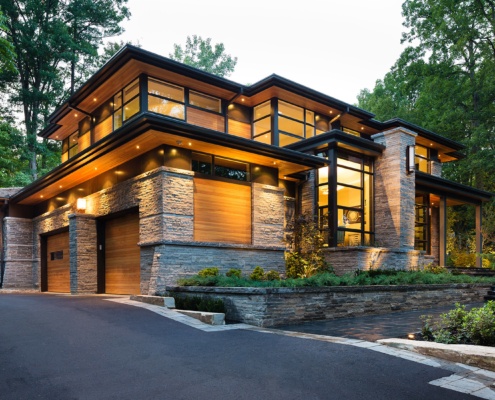 Natural modern house with floating roof, corner window and wood siding.