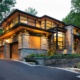 Natural modern house with floating roof, corner window and wood siding.