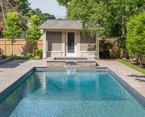 Flagstone patio with inground pool, hot tub and pool cabana.