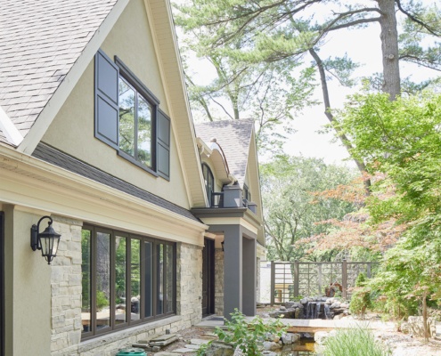 Mississauga house with gables, dark frame windows and 2 car garage.