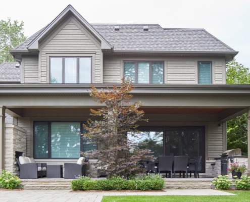 Stone porch with outdoor kitchen, stone fireplace and wood soffit.